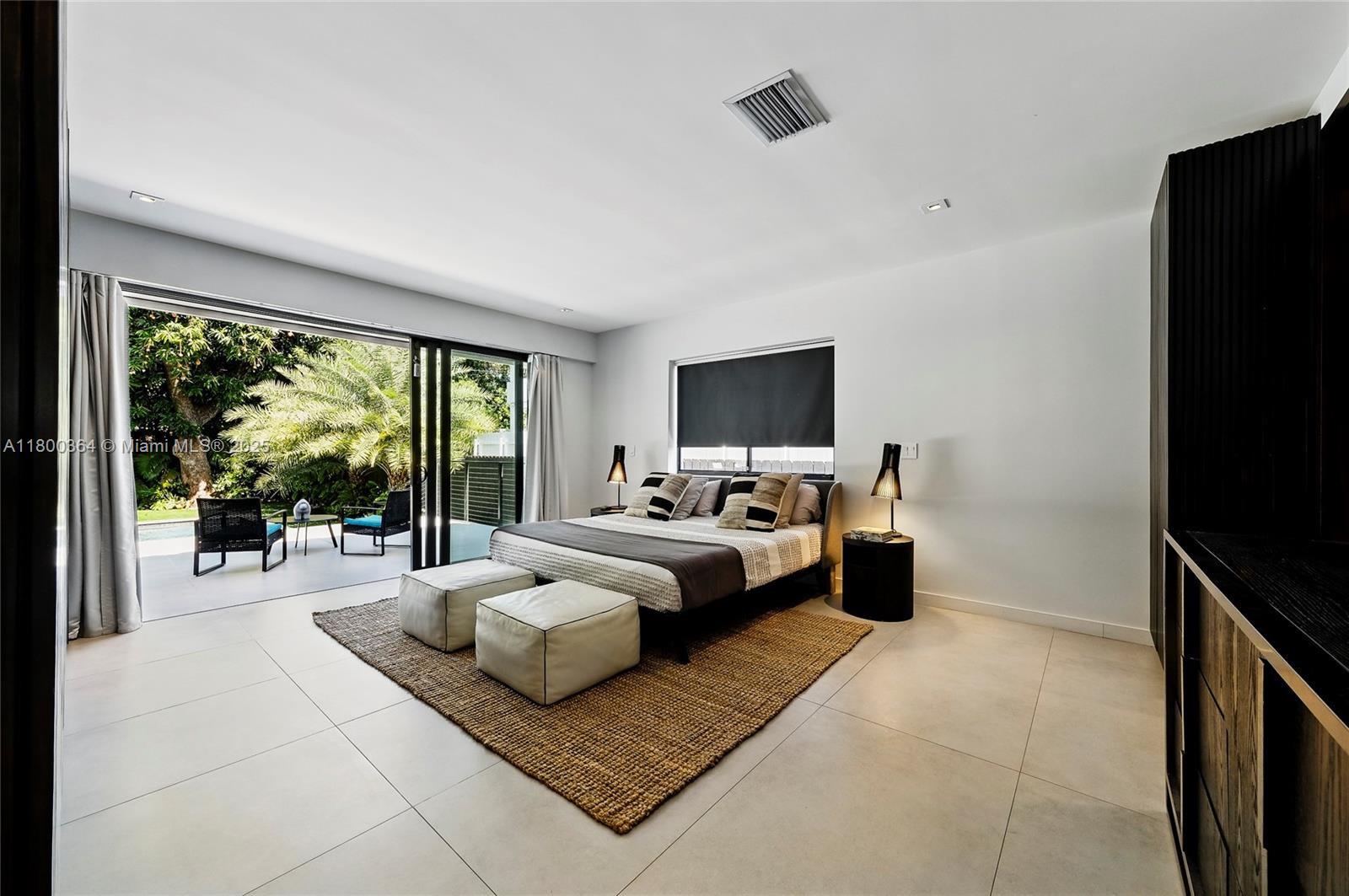4275 Prairie Avenue Miami Beach, FL 33140 - Photo 30 of 61 a bedroom with furniture and a flat screen tv