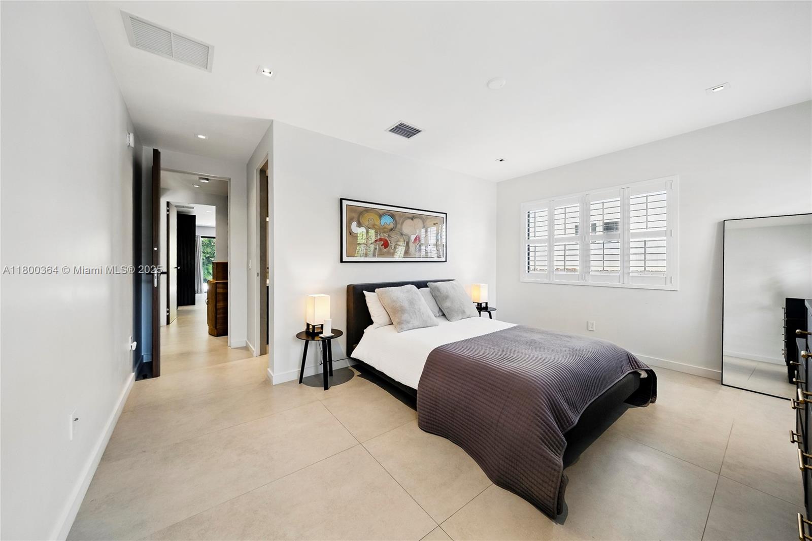 4275 Prairie Avenue Miami Beach, FL 33140 - Photo 43 of 61 a bedroom with a bed and a large mirror