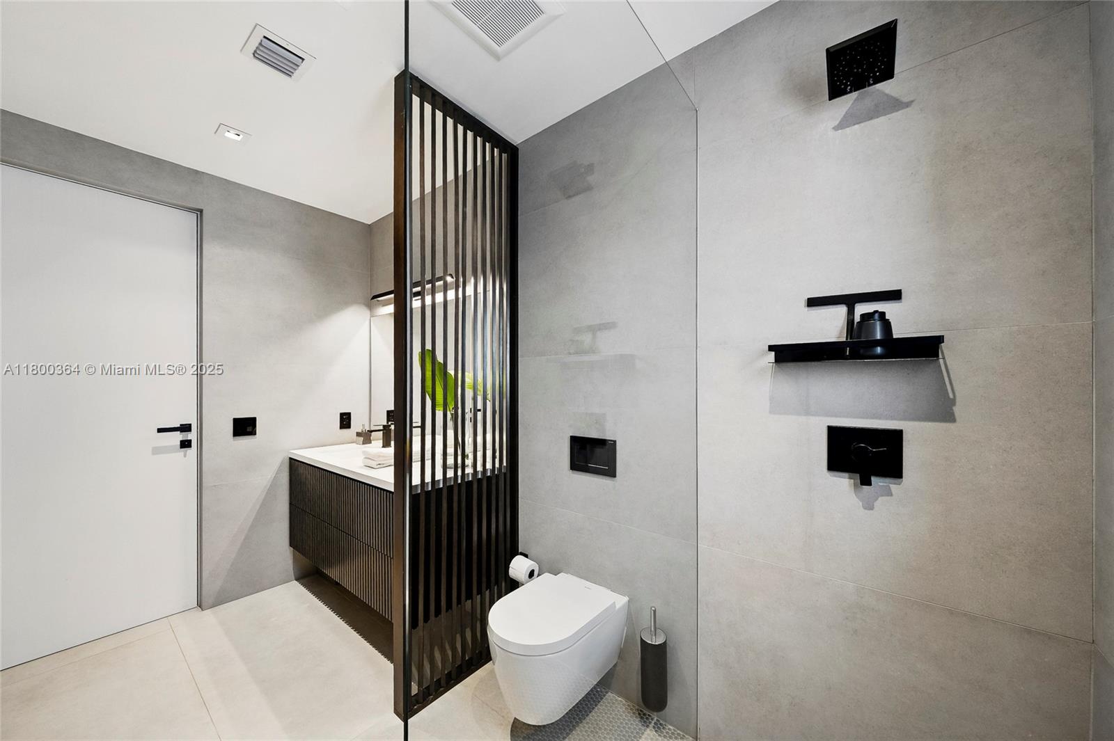 4275 Prairie Avenue Miami Beach, FL 33140 - Photo 48 of 61 a bathroom with a toilet sink and mirror