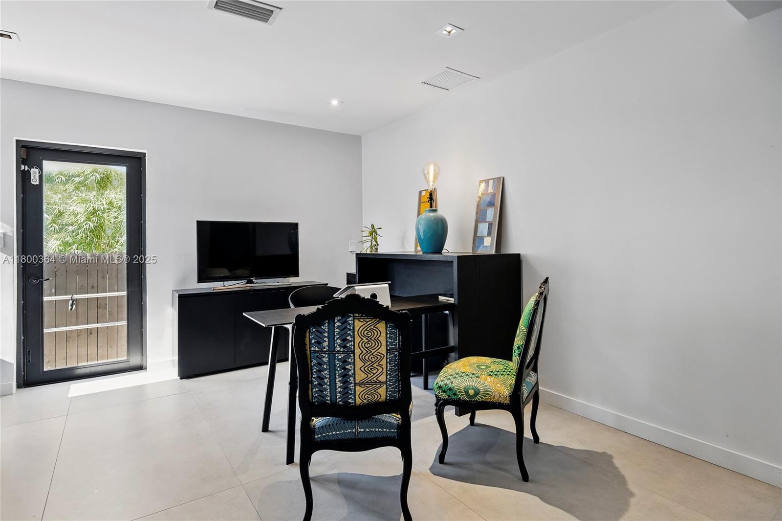 4275 Prairie Avenue Miami Beach, FL 33140 - Photo 53 of 61 a view of a livingroom with furniture and a flat screen tv