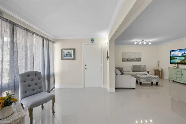 a living room with furniture and white furniture