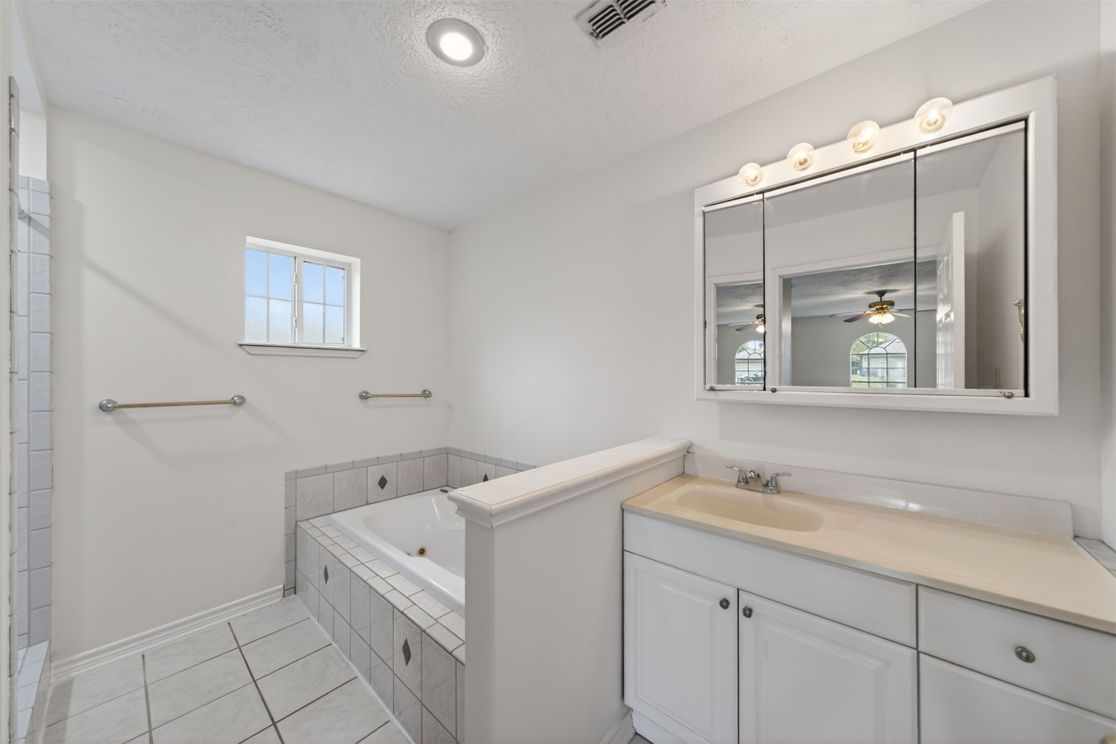 418 Texas Street Tomball, TX 77375 - Photo 10 of 31 Primary bathroom. (Virtually staged/AI enhanced). Image does not represent actual property as is.