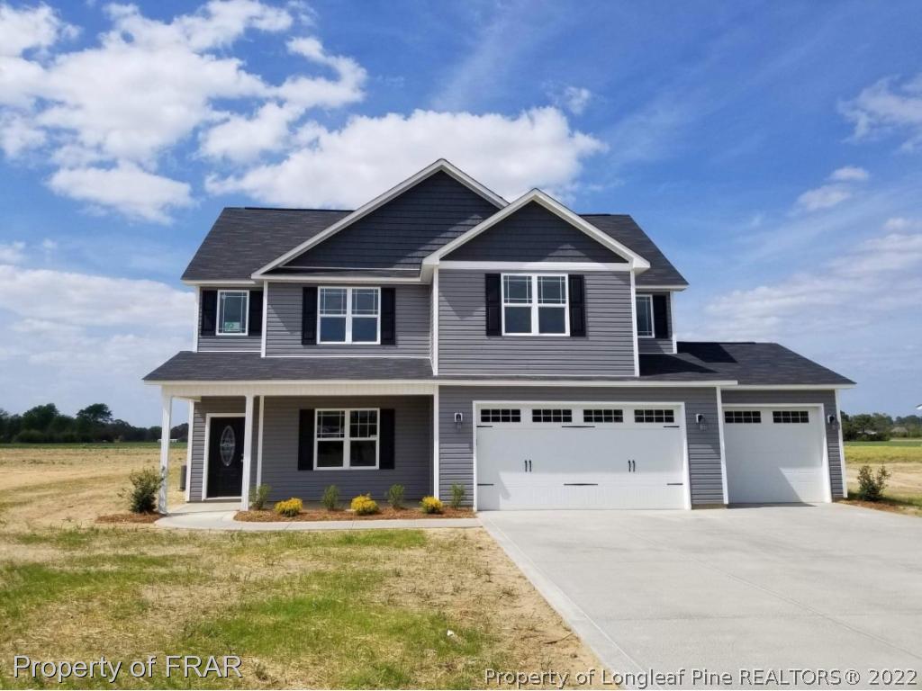 3627 Thrower Road Hope Mills, NC 28348 - Photo 1 of 35 a front view of a house with a yard and garage