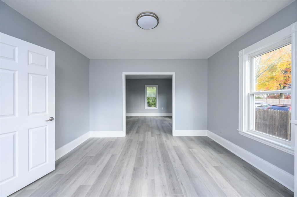 485 Temple Street Whitman, MA 02382 - Photo 12 of 34 a view of empty room with window and wooden floor