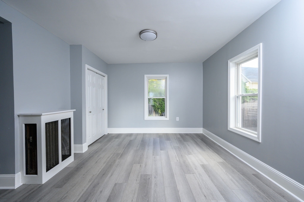 485 Temple Street Whitman, MA 02382 - Photo 14 of 34 an empty room with wooden floor and windows