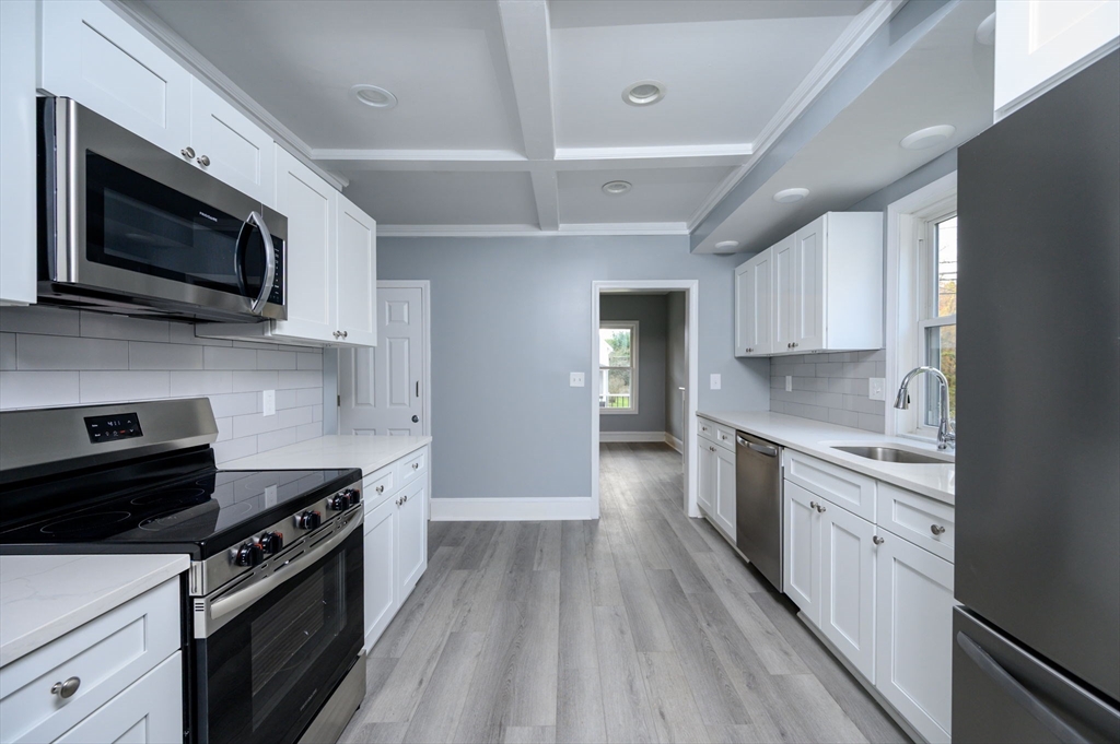 485 Temple Street Whitman, MA 02382 - Photo 5 of 34 a kitchen with stainless steel appliances a stove microwave and cabinets