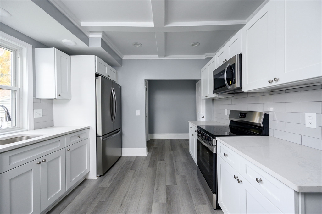 485 Temple Street Whitman, MA 02382 - Photo 6 of 34 a kitchen with stainless steel appliances a sink dishwasher a refrigerator and a stove with wooden floor