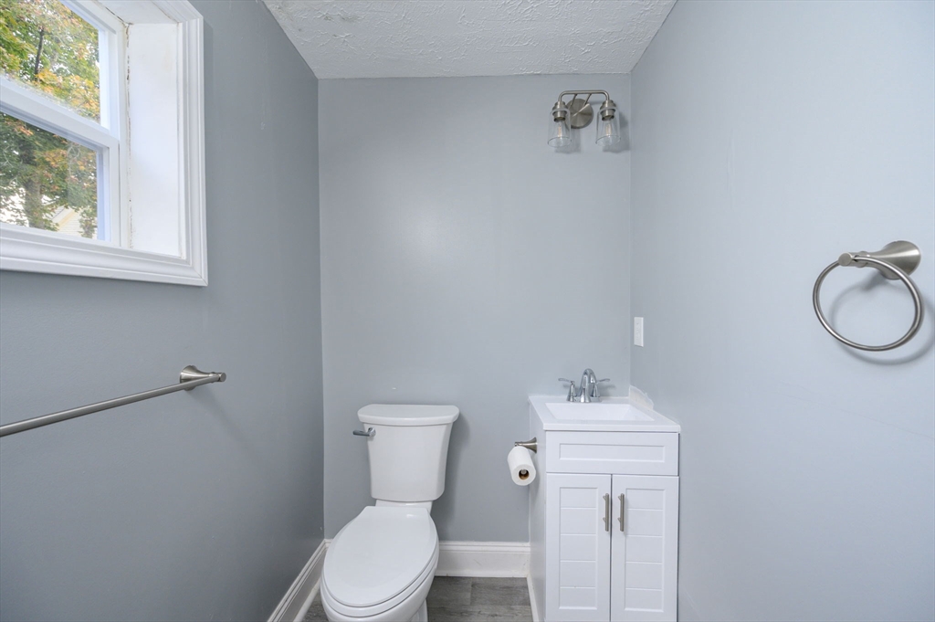 485 Temple Street Whitman, MA 02382 - Photo 10 of 34 a white toilet sitting next to a bathroom sink