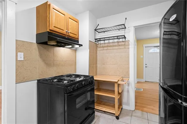 a kitchen with stainless steel appliances granite countertop a stove and a refrigerator