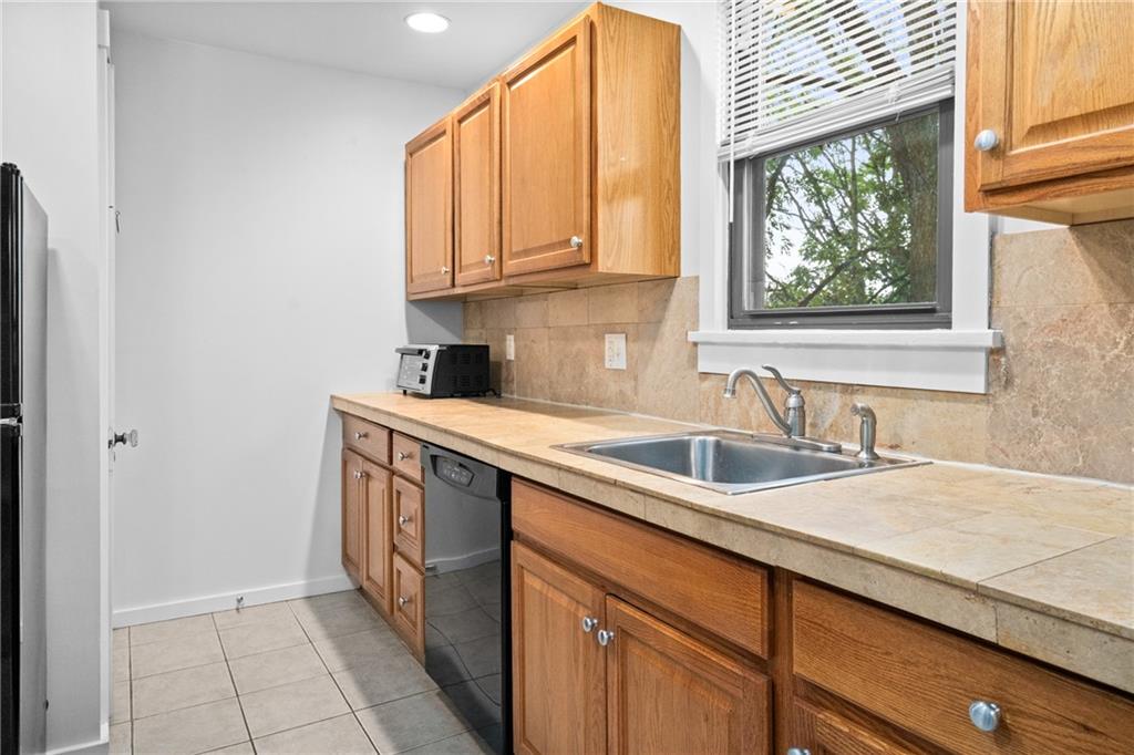 3612 Main Street Homestead, PA 15120 - Photo 13 of 30 a kitchen with stainless steel appliances granite countertop a sink and a window
