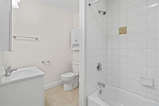 a bath room with a toilet sink and shower
