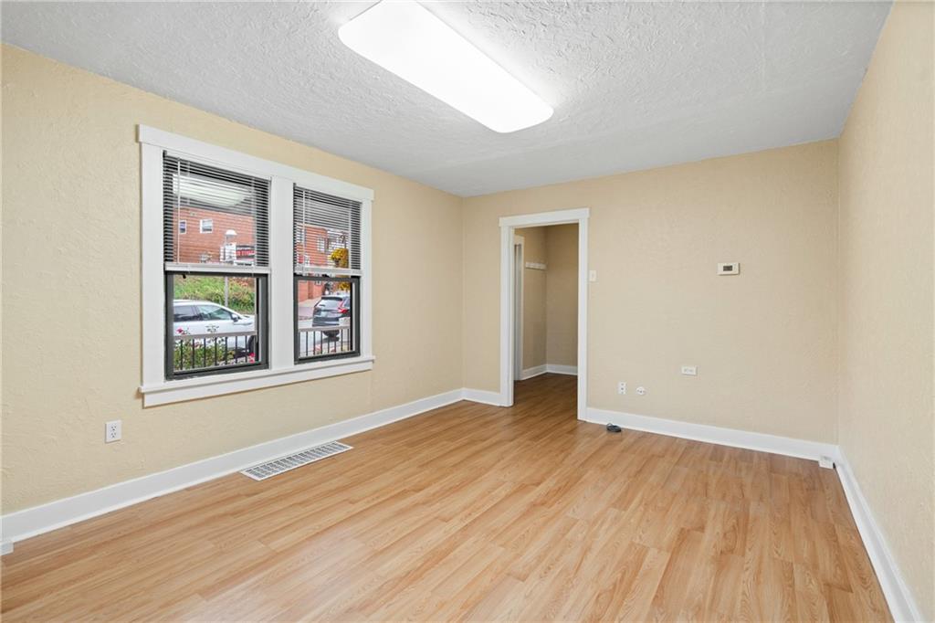 3612 Main Street Homestead, PA 15120 - Photo 7 of 30 an empty room with wooden floor and windows
