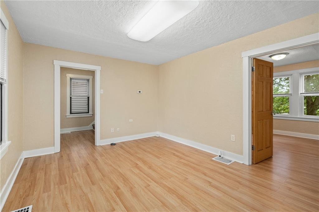 3612 Main Street Homestead, PA 15120 - Photo 8 of 30 a view of an empty room with wooden floor and a window