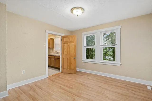 an empty room with windows and closet