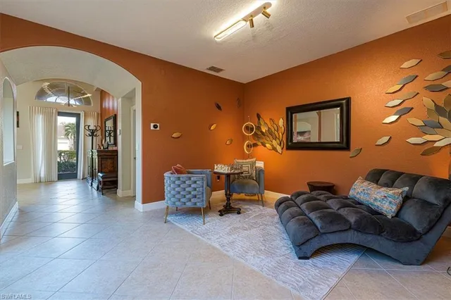 a living room with furniture and a lamp