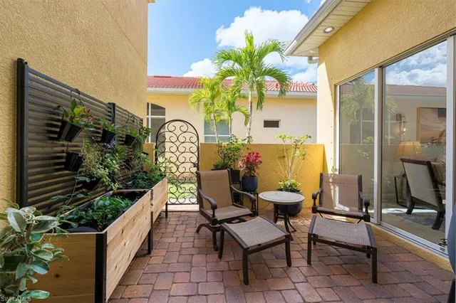a view of a chairs and table in a balcony