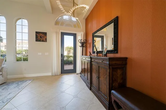 a view of a hallway with entryway and dining room