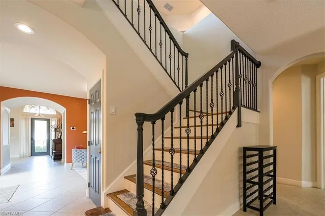a view of staircase with wooden floor and frames on wall