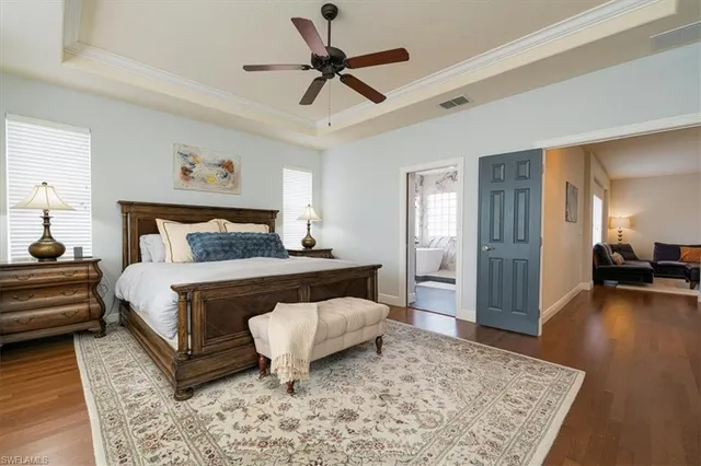 a bedroom with a large bed and a chandelier