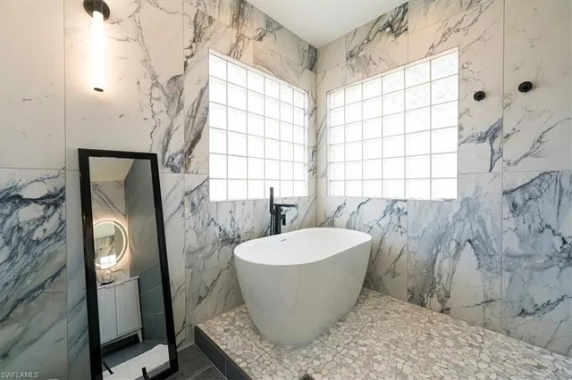 a view of a bathroom with a tub and window