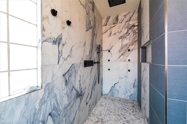 a bedroom with a bed and a flat tv screen on dresser