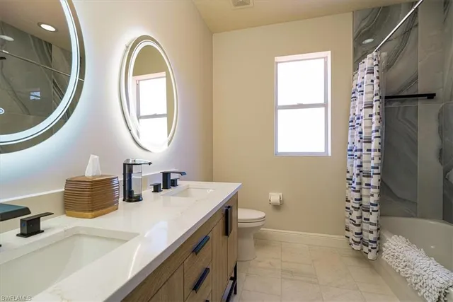 a bedroom with two beds and a window