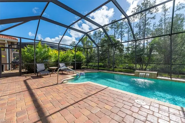 a view of a patio with a table chairs and a yard