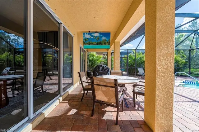 a dinning table and chairs in patio of the house