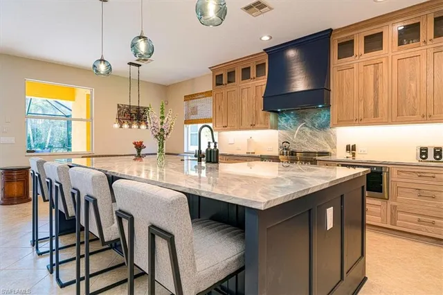 a kitchen with granite countertop a sink cabinets and window