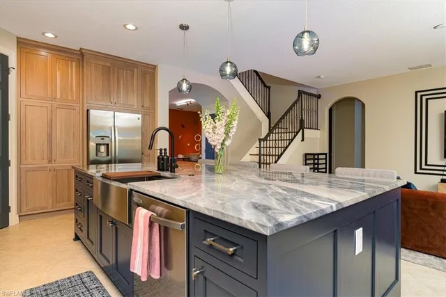 a kitchen with stainless steel appliances granite countertop a stove a sink and a refrigerator
