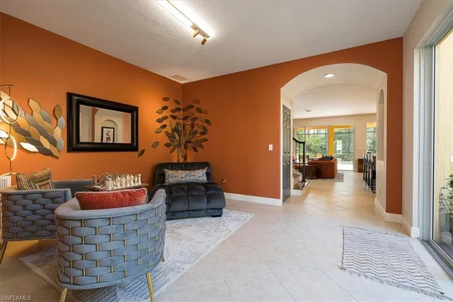 a hallway with a couch and chandelier