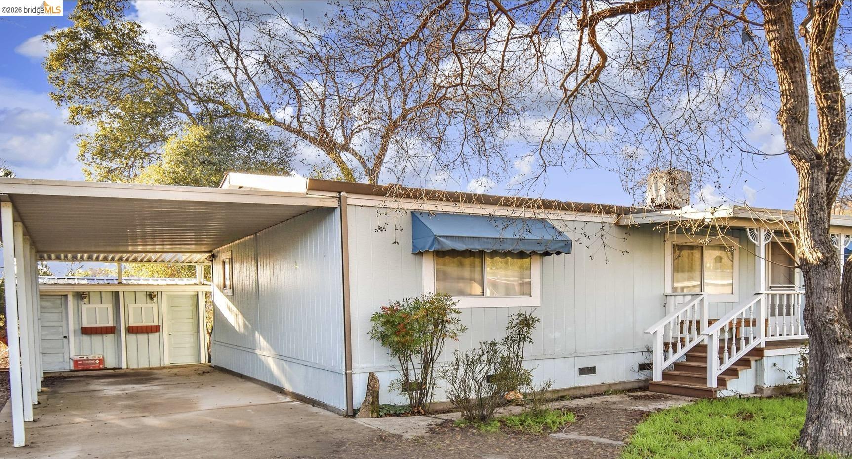 18330 Wards Ferry, Unit 32 Sonora, CA 95370 - Photo 12 of 36 View of front of home with crawl space, an attached carport, and concrete driveway
