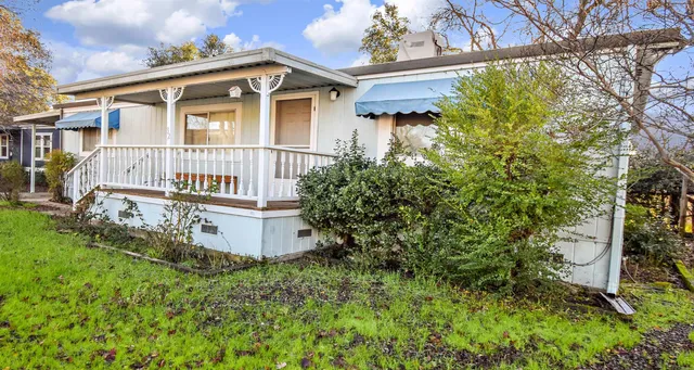 a front view of a house with a yard and fountain