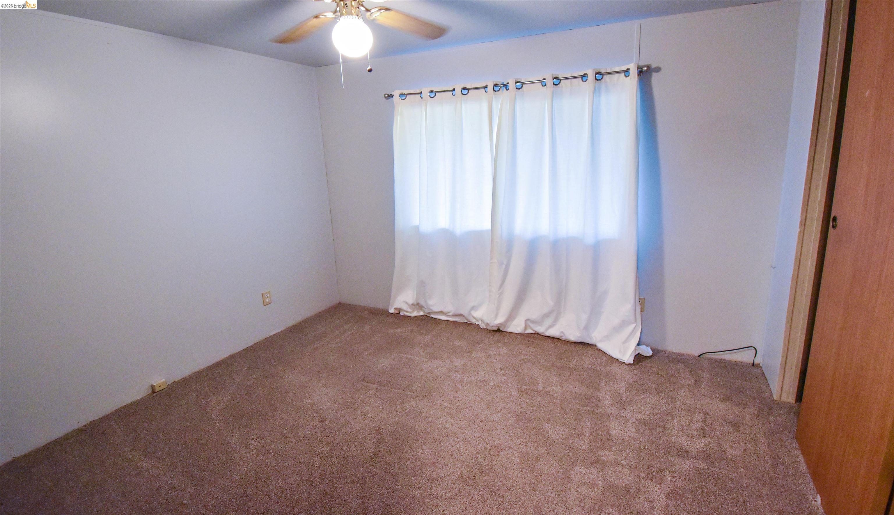 18330 Wards Ferry, Unit 32 Sonora, CA 95370 - Photo 32 of 36 Unfurnished room with a ceiling fan and carpet floors