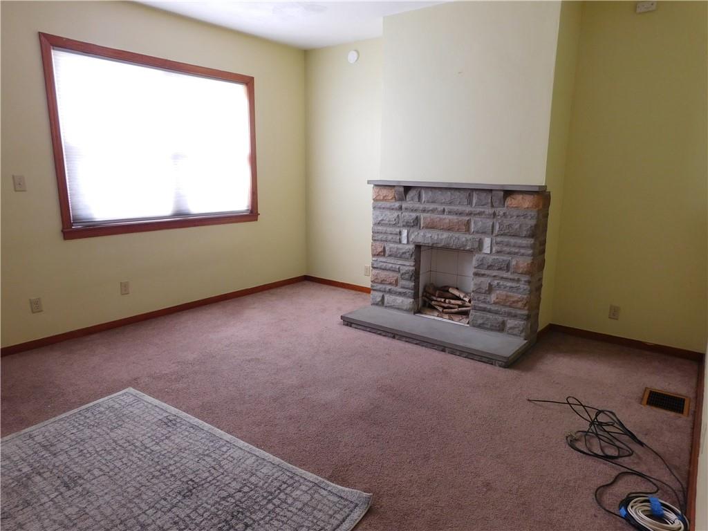 119 April Way Braddock, PA 15104 - Photo 3 of 16 an empty room with a fireplace and window