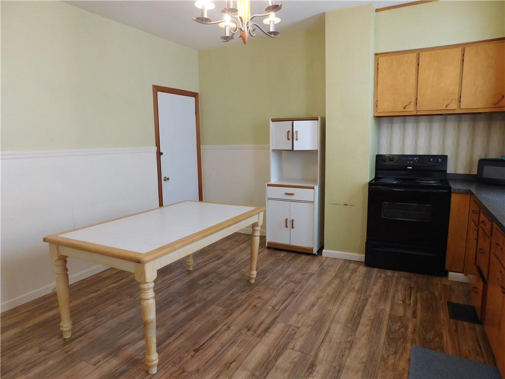 119 April Way Braddock, PA 15104 - Photo 5 of 16 a kitchen with cabinets and wooden floor