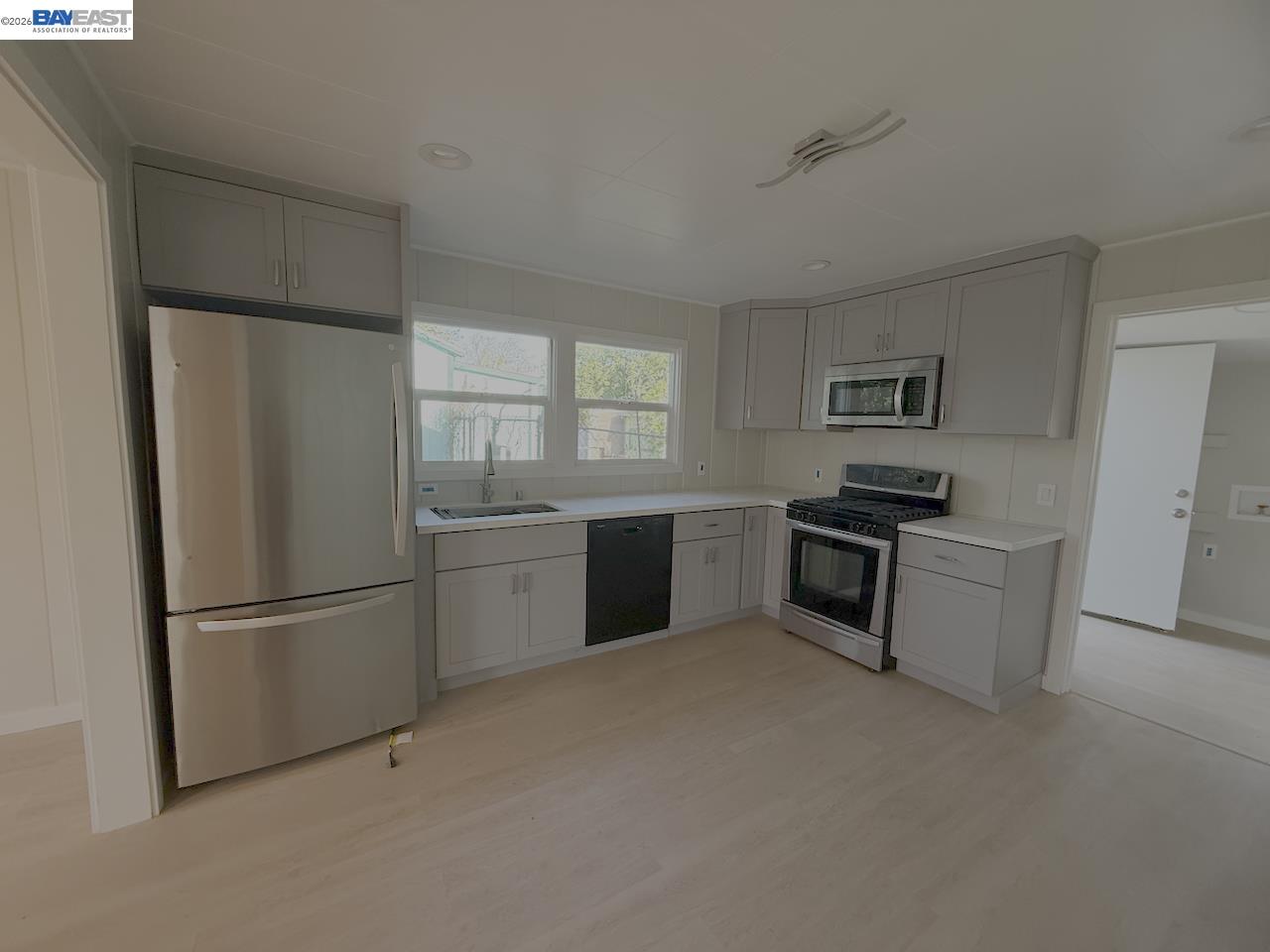 1324 Trenary Way Modesto, CA 95354 - Photo 4 of 17 a kitchen with a refrigerator and a sink