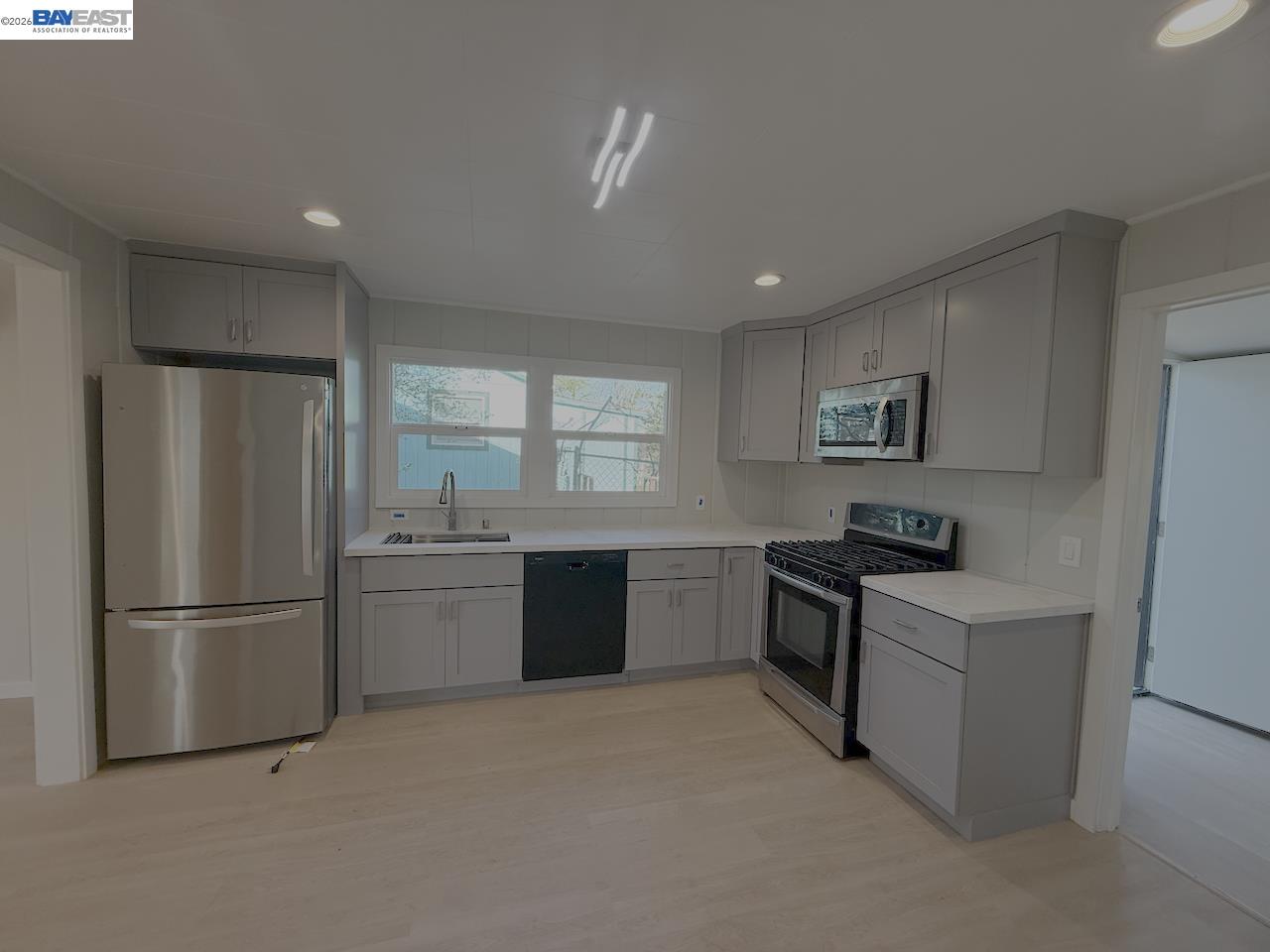 1324 Trenary Way Modesto, CA 95354 - Photo 5 of 17 a kitchen with granite countertop stainless steel appliances and refrigerator