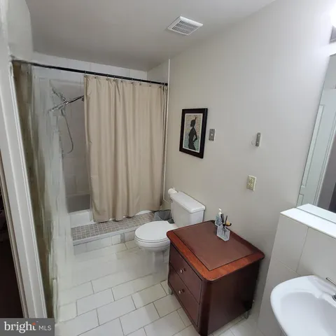 a bathroom with a toilet a sink and a shower