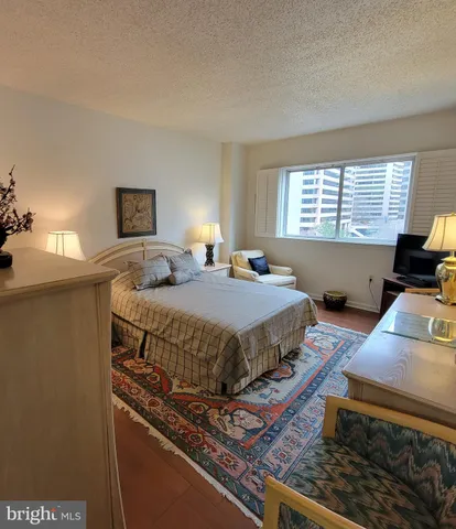 a bedroom with bed and window