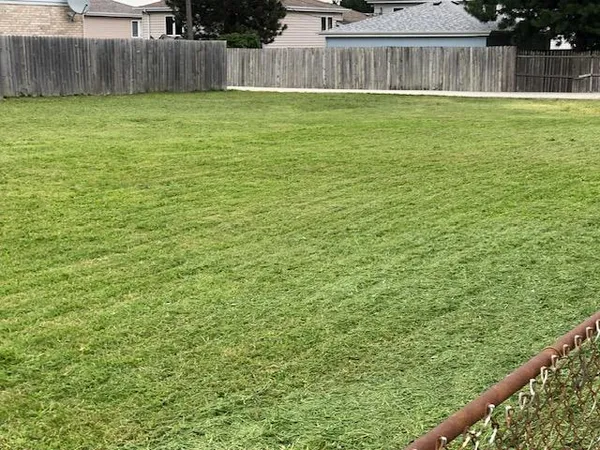 a view of a backyard with a fence