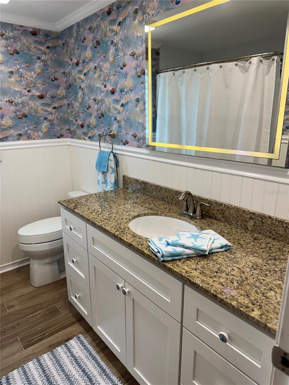 4385 7th Isle Drive Hernando Beach, FL 34607 - Photo 14 of 25 a bathroom with a granite countertop sink and a mirror