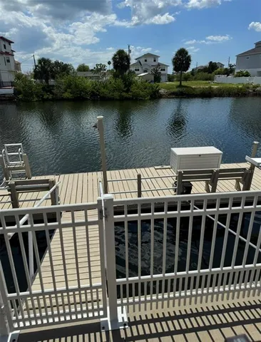 a view of a balcony with wooden floor and lake view