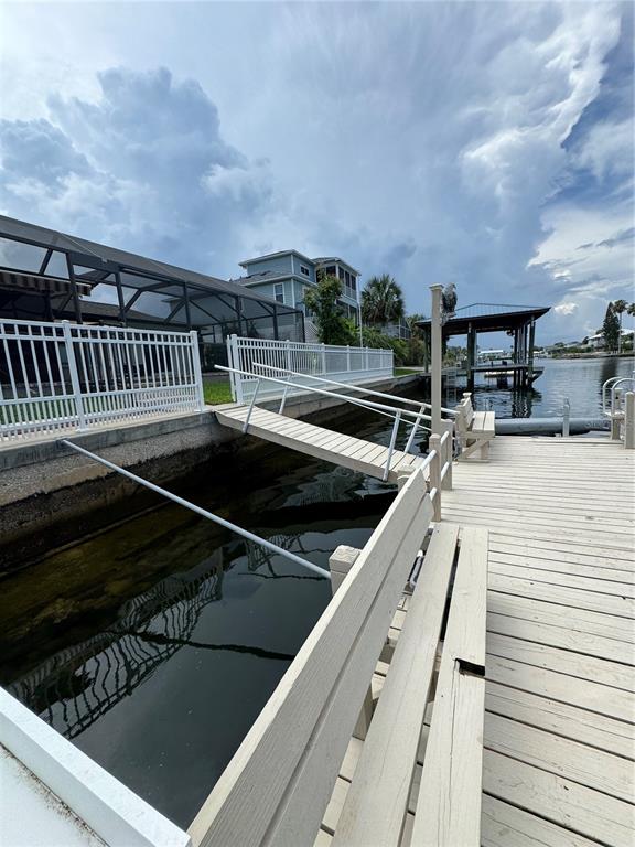 4385 7th Isle Drive Hernando Beach, FL 34607 - Photo 17 of 25 a terrace with outdoor seating and trees