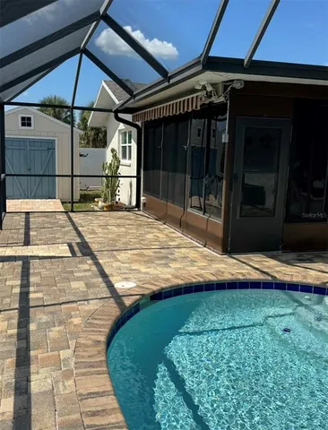 a room with pool table and chairs