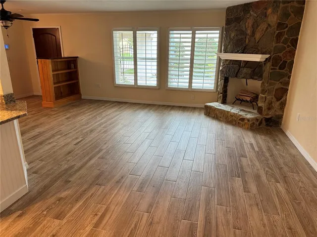 a room with wooden floor and furniture