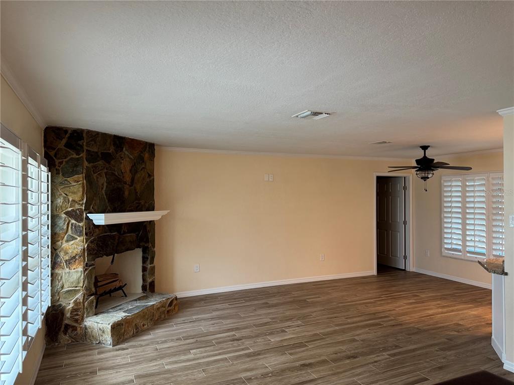 4385 7th Isle Drive Hernando Beach, FL 34607 - Photo 4 of 25 a view of an empty room with wooden floor and a window