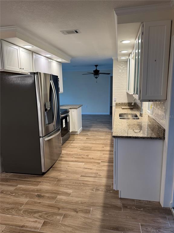 4385 7th Isle Drive Hernando Beach, FL 34607 - Photo 8 of 25 a kitchen with stainless steel appliances granite countertop a refrigerator and a sink