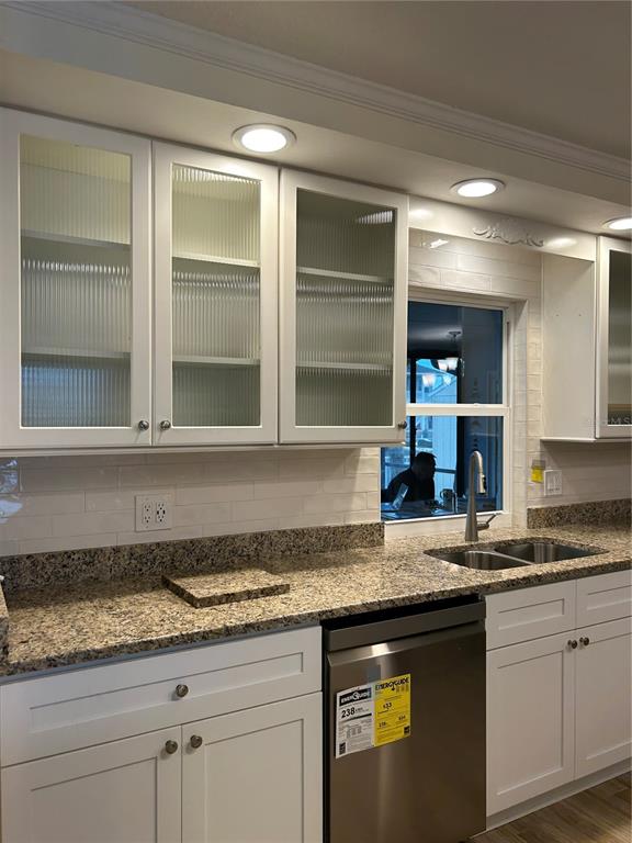 4385 7th Isle Drive Hernando Beach, FL 34607 - Photo 9 of 25 a kitchen with granite countertop a sink and a stove