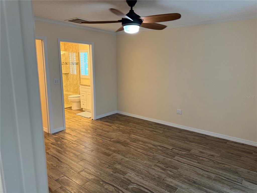 4385 7th Isle Drive Hernando Beach, FL 34607 - Photo 10 of 25 a view of empty room with wooden floor and fan